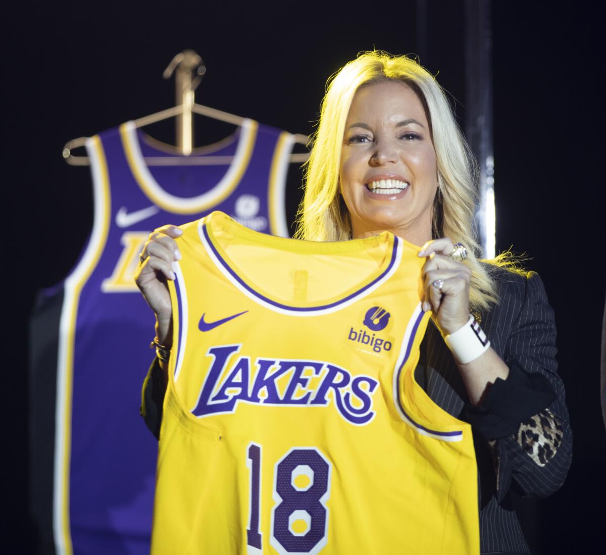 Lakers co-owner Jeanie Buss holds up a Lakers jersey.