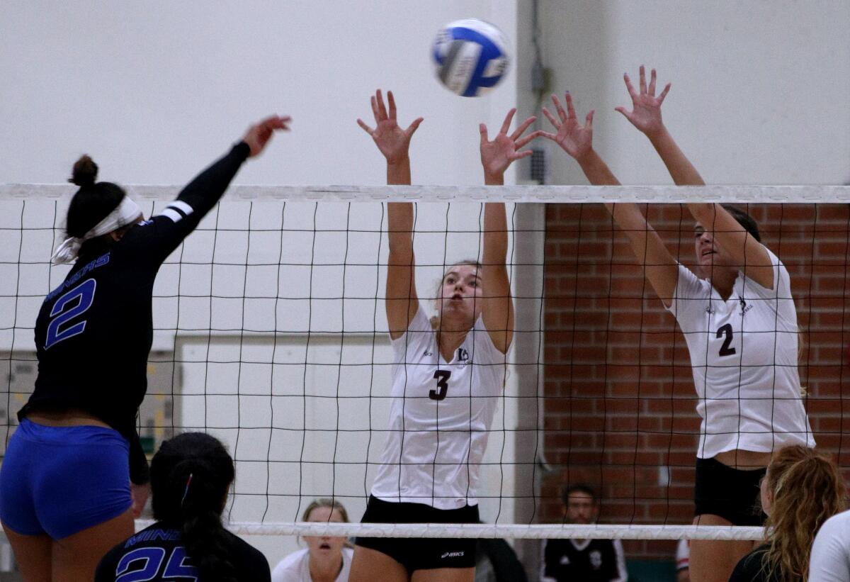 Laguna Beach players Sophie Reavis (3) and Kendall Fraser (2) go up for the block during a match against South Jordan Bingham of Utah in the Dave Mohs Memorial Tournament at Edison High on Saturday.