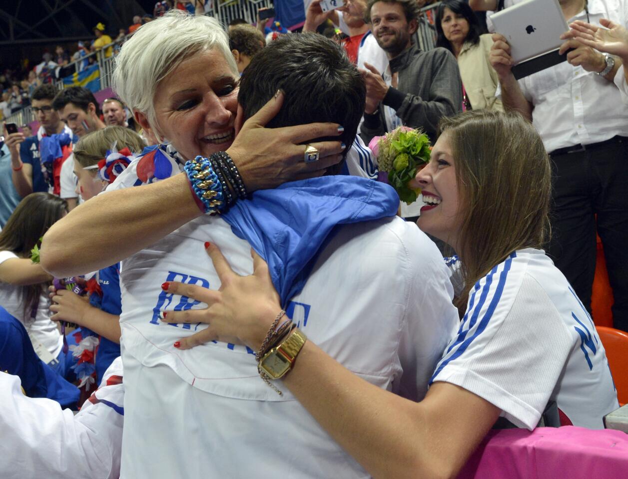 France's centreback Nikola Karabatic (C) celebrates with his mother Radmila (L) after winning the men's gold medal handball match between Sweden and France for the London 2012 Olympics Games on August 12, 2012 at the Basketball Arena in London.