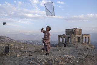 A boy flies a kite on Tape Nadir Khan hill in Kabul, Afghanistan, on Saturday, Dec. 4 , 2021. (AP Photo/Petros Giannakouris)