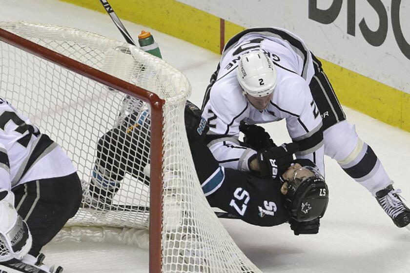The Kings' Matt Greene slams San Jose's Tommy Wingels to the ice during the third period of Game 2 of the teams' playoff series on April 20.