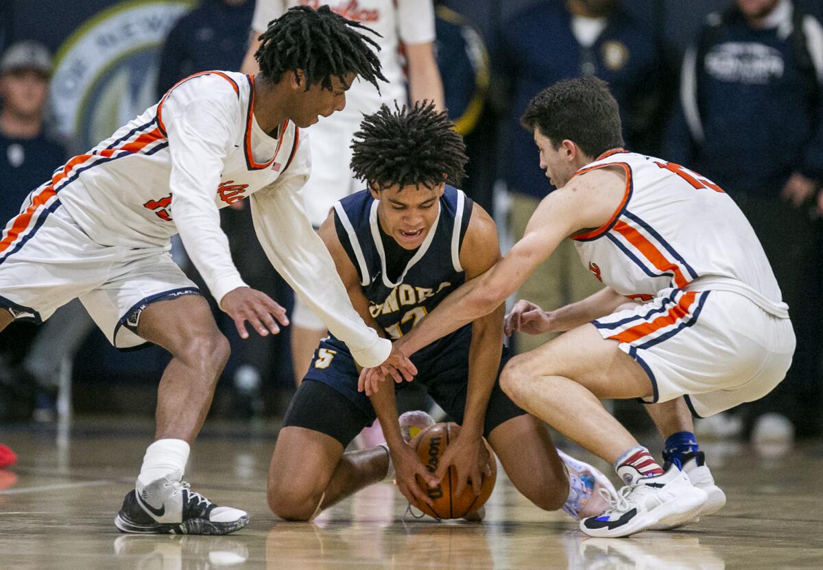 Pacifica Christian's Jeffrey Bohlinger, left, and Tanner Deal, right, scramble for a loose ball against Sonora's Yanmife Oke.