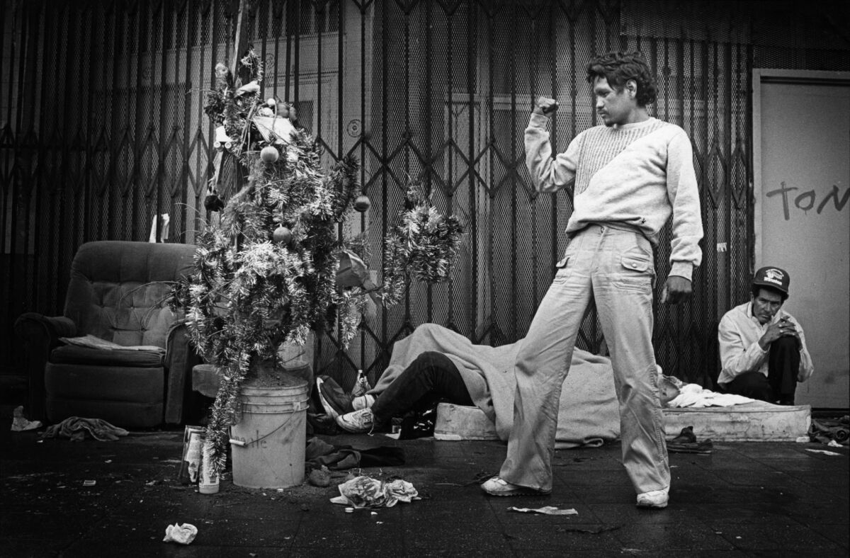 Dec. 20, 1988: Ernesto "Angel" Perez, 31, reacts after decorating a tree that he and homeless friends set up where they sleep.