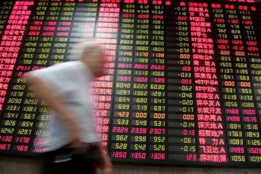 An investor walks past the stock price monitor at a private securities company Thursday, Sept. 9, 2010 in Shanghai, China. Chinese shares fell Thursday on fears of possible new government curbs on real estate as investors waited for monthly economic data. The benchmark Shanghai Composite Index lost 38.94 points, or 1.4 percent, to close at 2,656.35. The Shenzhen Composite Index for China's smaller second exchange also shed 1.4 percent to end at 1,179.13. (AP Photo)