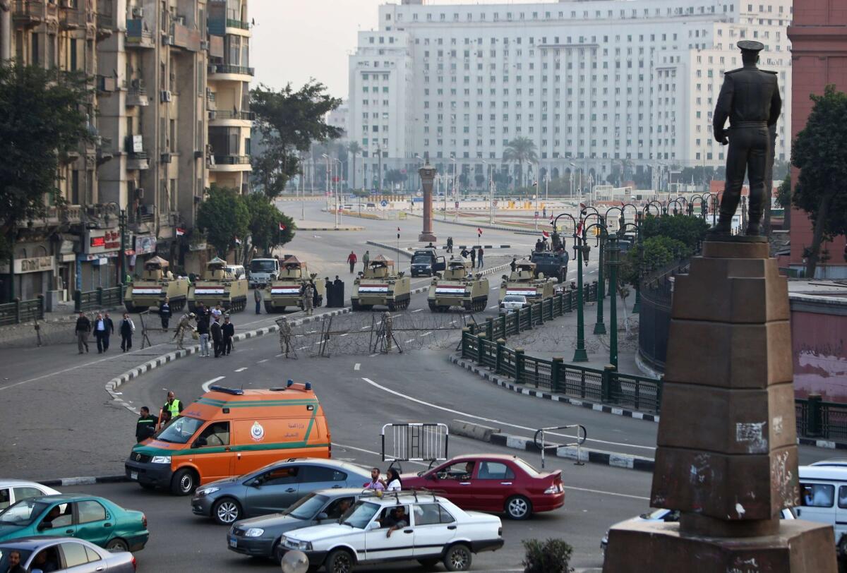 The Egyptian army blocks a road leading to Cairo's Tahrir Square on Friday during a demonstration against a court's decision to drop a murder charge against ousted President Hosni Mubarak.