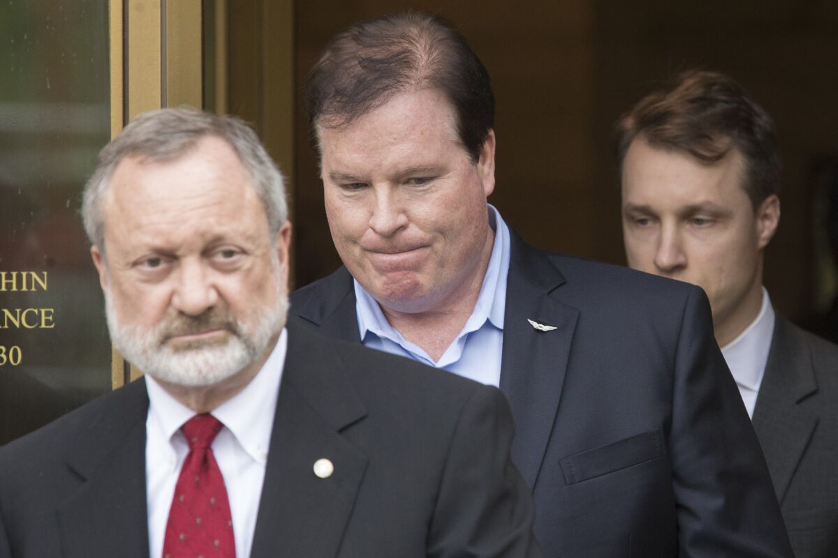 FILE - In this May 23, 2019, file photo, Chicago banker Stephen Calk, center, leaves Federal court , in New York with his attorney Jeremy Margolis, left. A Manhattan jury on Tuesday, July 13, 2021, convicted Calk of criminal charges for enabling Paul Manafort to get $16 million in loans before the former campaign manager for ex-President Donald Trump helped him get an interview for a job in the Trump administration. (AP Photo/Mary Altaffer, File)
