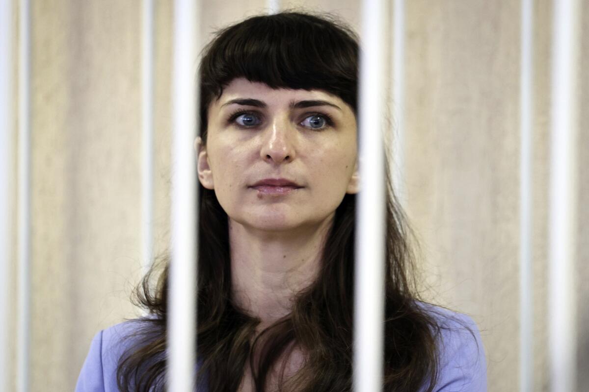 Belarusian journalist Katsiaryna Barysevich, seen in cage, attend a court hearing in Minsk, Belarus, Tuesday, March 2, 2021. On Tuesday, the Moskovsky District Court in Minsk sentenced Barysevich to six months in prison and a fine equivalent to $1,100. It also handed a two-year suspended sentence to Artsyom Sarokin, a doctor who treated protester and shared his medical records with Barysevich, and fined him the equivalent of $550. (Sergei Sheleg/BelTA Pool Photo via AP)
