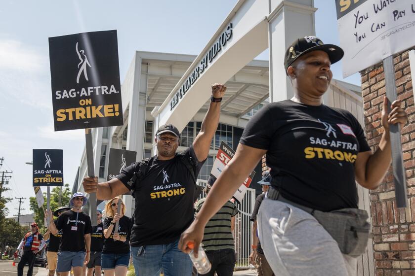 Screen Actors Guild members and Writers Guild of America members picket at the Amazon Culver Studios in Culver City on June 17, 2023. A bill would pay strikers unemployment benefits. Photo by Julie A Hotz for CalMatters