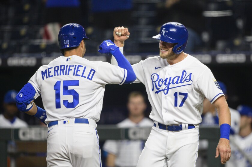 Kansas City Royals Hunter Dozier, right, congratulates Whit Merrifield, left, after Merrifield hit a home run scoring both of them during the fourth inning of a baseball game against the Cleveland Indians Monday, May 3, 2021, in Kansas City, Mo. (AP Photo/Reed Hoffmann)