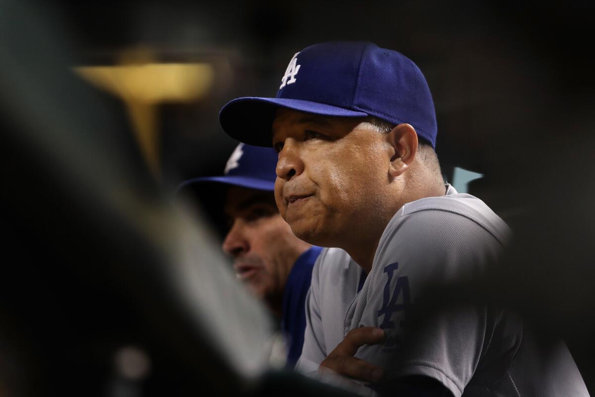 Dodgers Manager Dave Roberts watches from the dugout on Sept. 15.