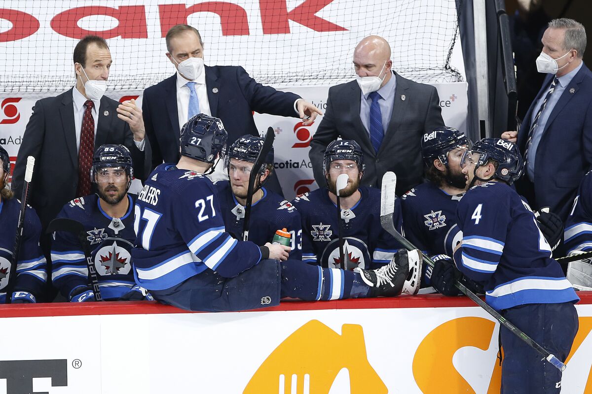 Winnipeg Jets coach Paul Maurice talks to players during the third period of Game 2 of an NHL hockey Stanley Cup second-round playoff series against the Montreal Canadiens on Friday, June 4, 2021, in Winnipeg, Manitoba. (John Woods/The Canadian Press via AP)