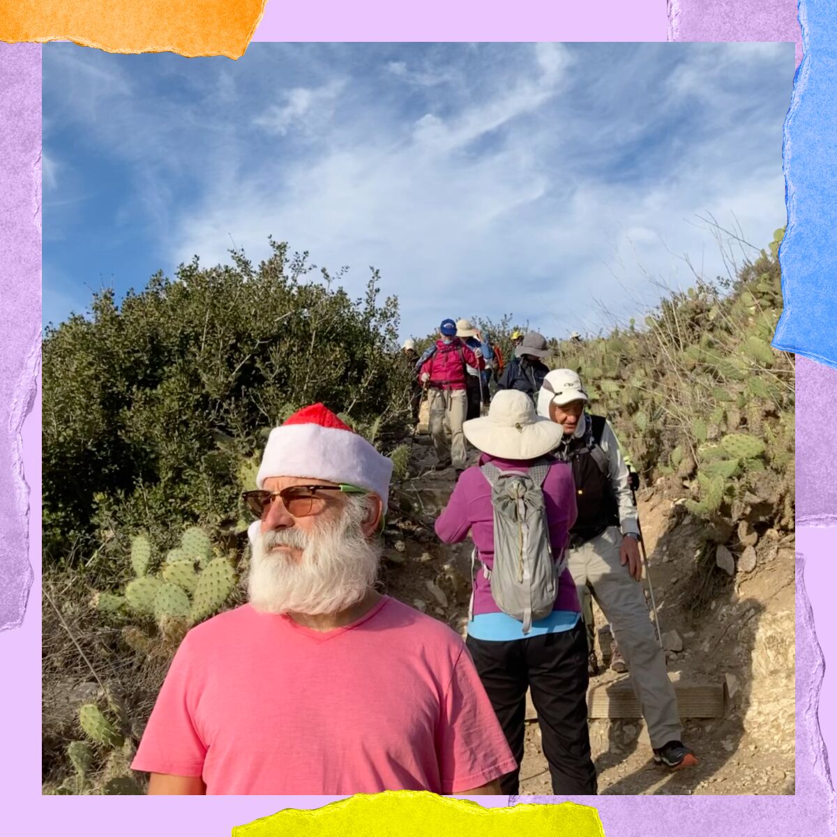 A man in a Santa hat along with other Sierra Club hikers in San Pedro