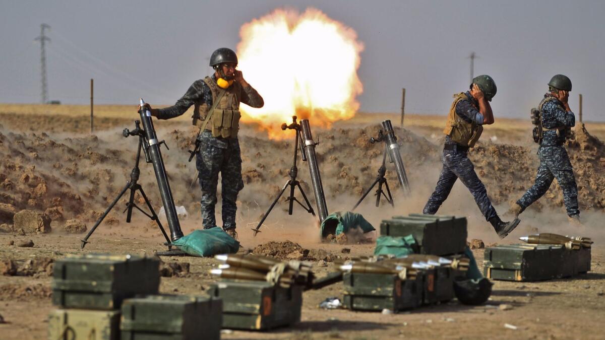 Iraqi soldiers fire mortars against Kurdish peshmerga positions in an area near the Turkish and Syrian borders in the Iraqi Kurdish autonomous region on Thursday.