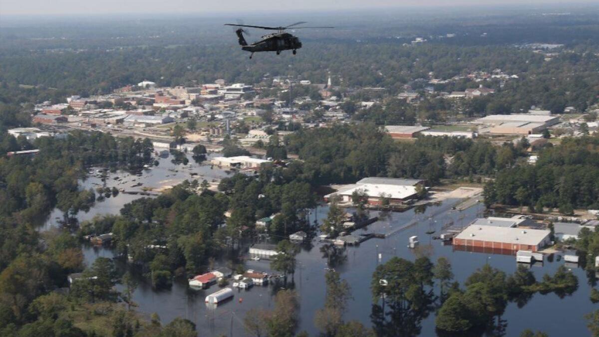 A U.S. Army helicopter flies Sept. 20 over a portion of Lumberton, N.C., flooded after Hurricane Florence.