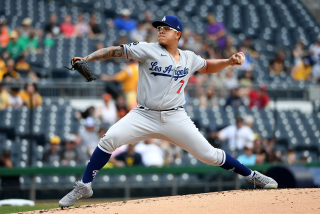 Former Dodgers pitcher Julio Urias throws from the mound.