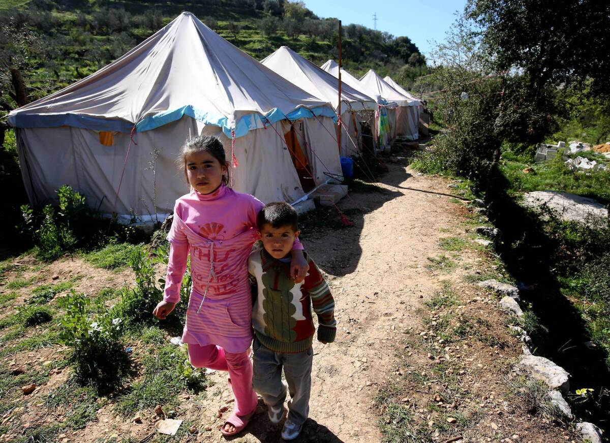 Syrians make their way at a refugee camp in Ketermaya, Lebanon.