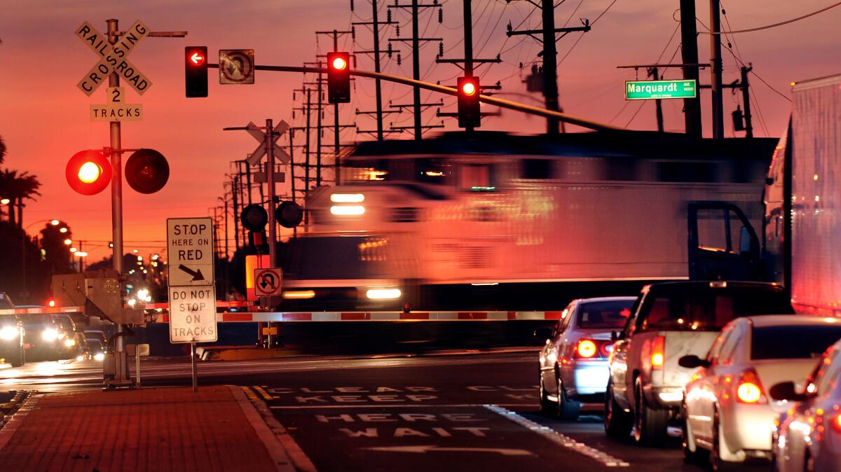 A Metrolink train crosses the intersection of Rosecrans and Marquardt avenues in Santa Fe Springs, where an overpass will be built to prevent collisions between trains, cars and pedestrians.