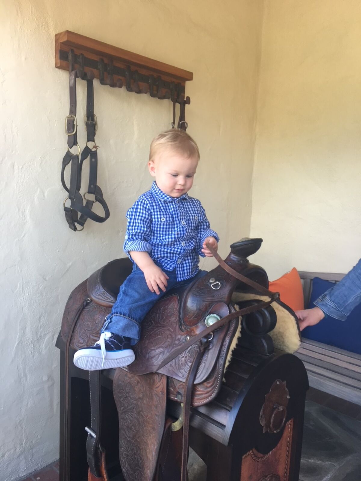Buck Bennett's grandson Braxton on his old saddle.