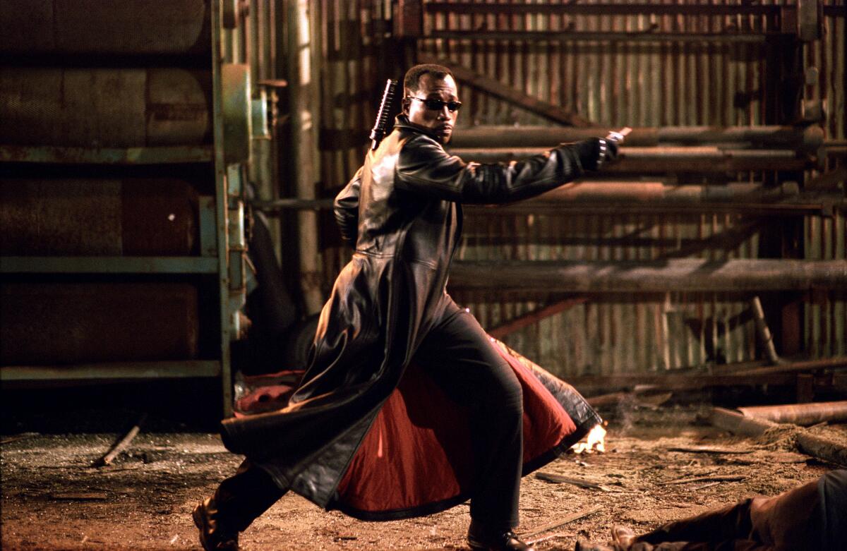 Wesley Snipes wears a cape and black sunglasses as Blade.