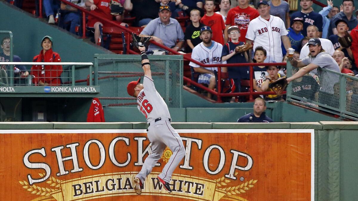 Angels right fielder Kole Calhoun makes a leaping catch to rob Boston's Brock Holt of a home run during a Aug. 19 game.