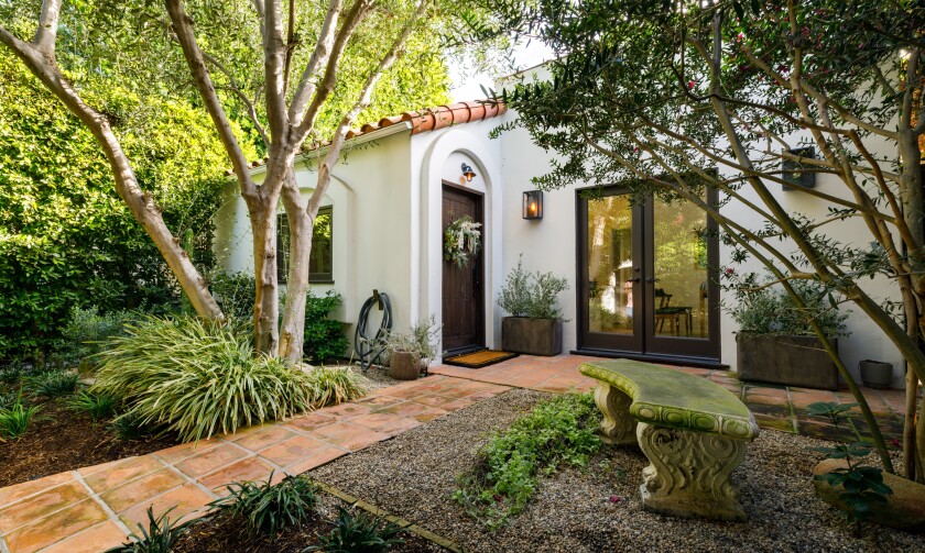Built in the 1920s, the single-story bungalow expands to a leafy backyard with olive and lemon trees.