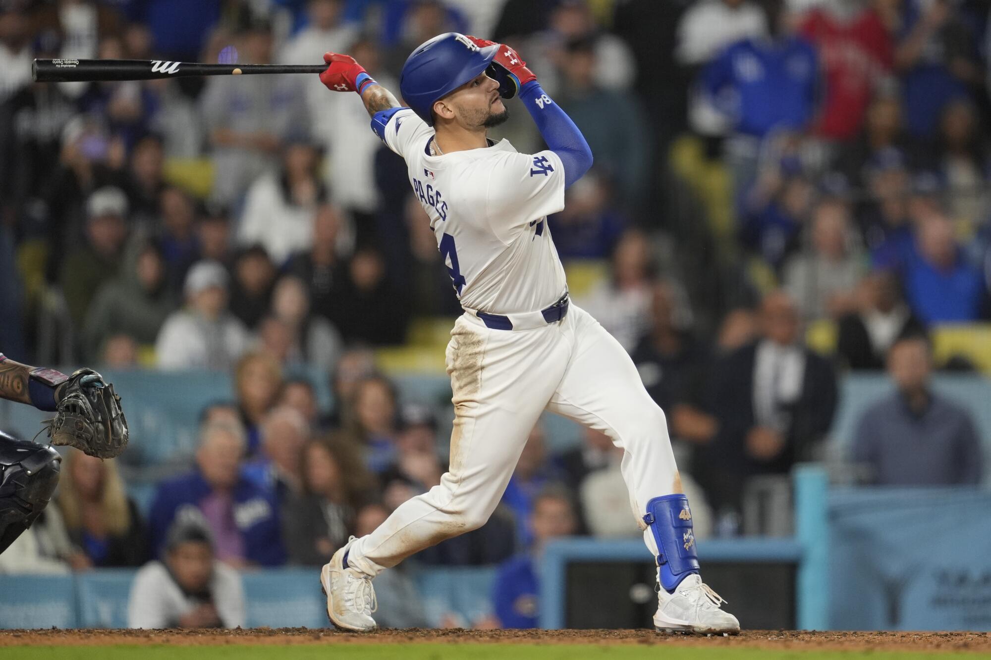 Los Angeles Dodgers' Andy Pages singles during the eleventh inning of a baseball game.