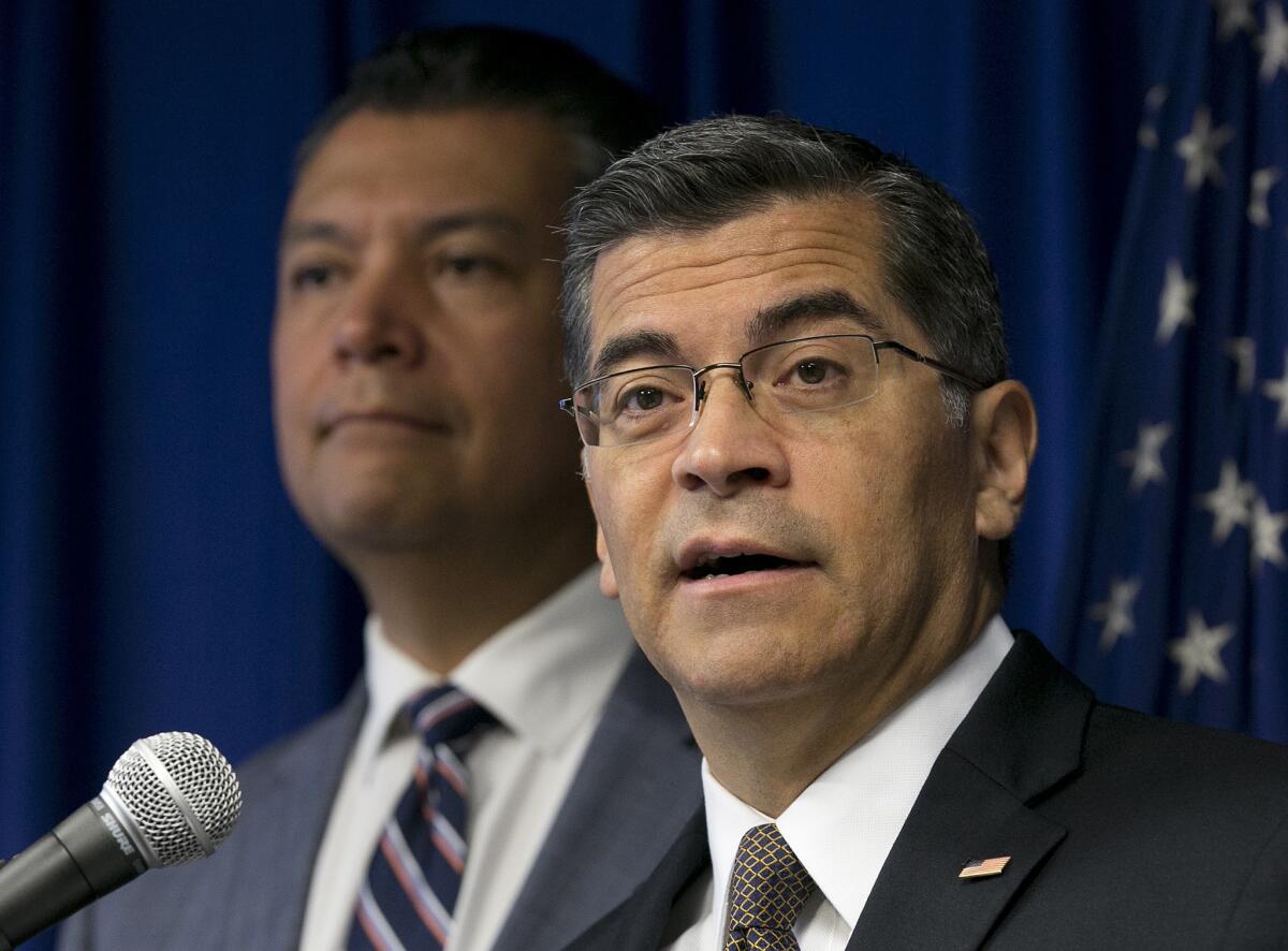 California Atty. Gen. Xavier Becerra, right, flanked by Secretary of State Alex Padilla, during a 2017 news conference.