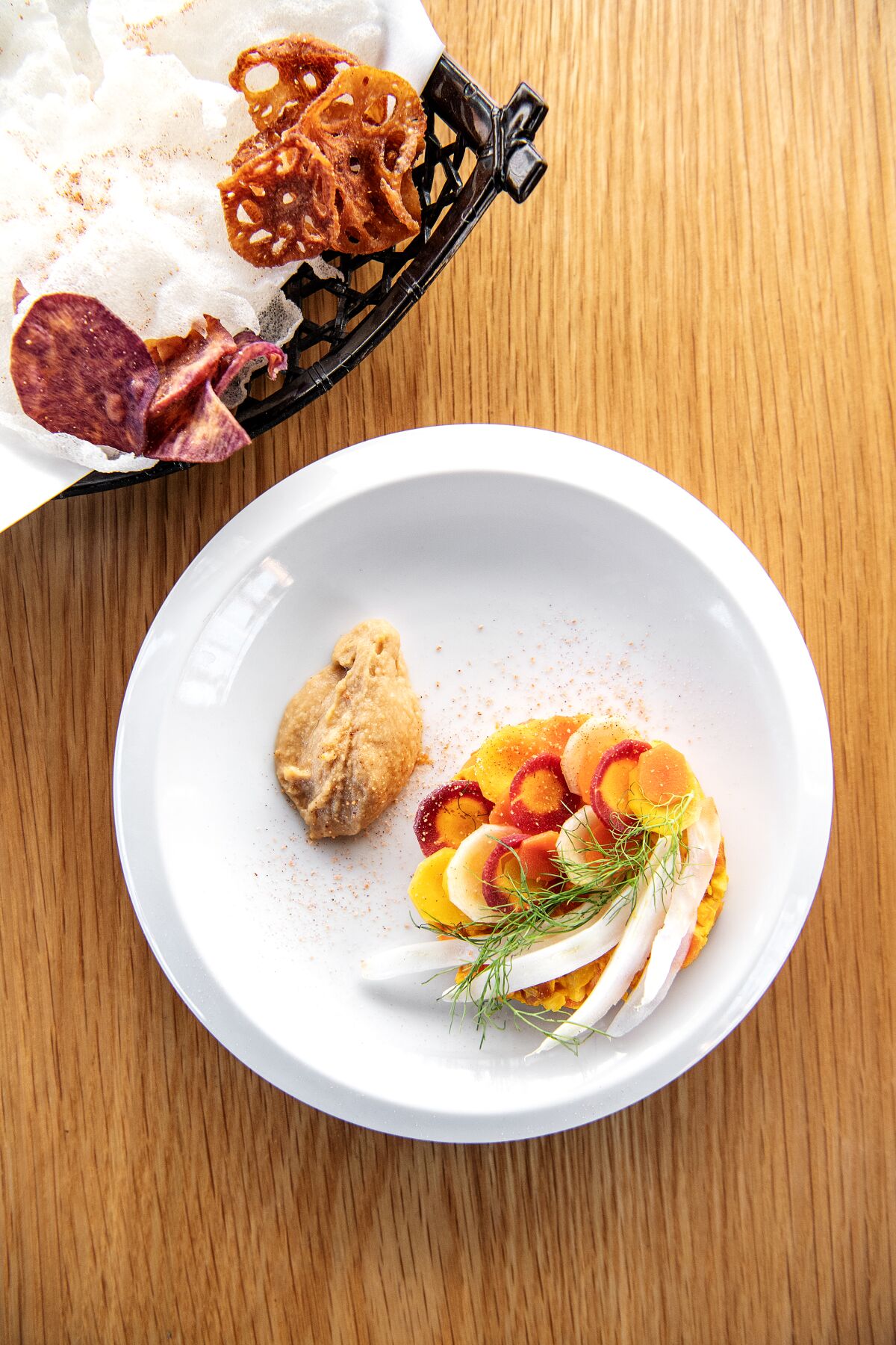 A sparsely arranged plate of carrot and fennel tartare