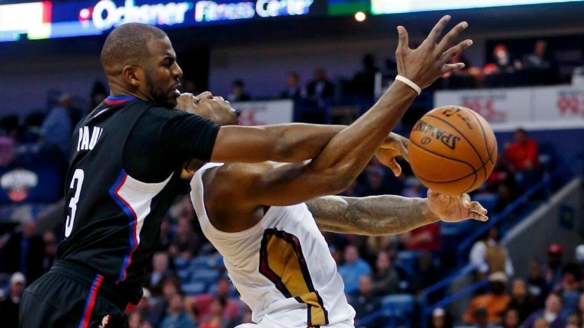 Clippers guard Chris Paul commits a flagrant foul on Pelicans guard Tim Frazier during the second half of a game on Dec. 2.