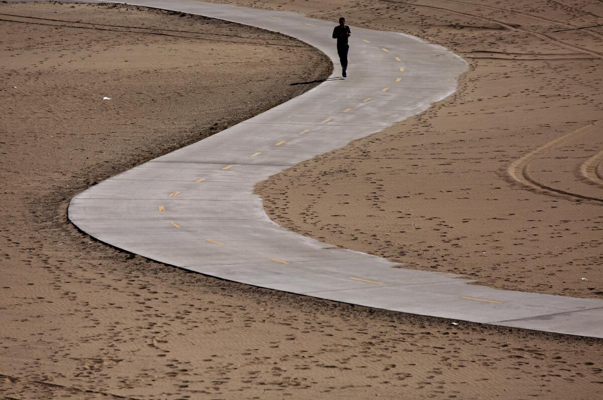 Some in Playa Del Rey discover a near empty beach after Los Angeles County announced the closures of all beaches and trails.