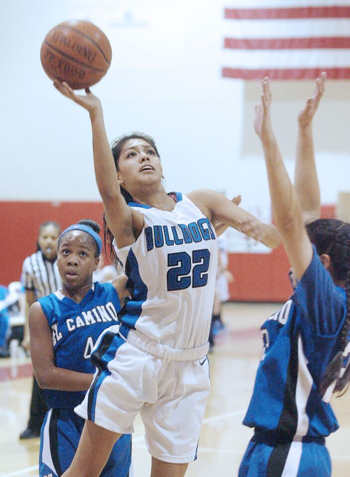 Burbank's Jamie Gonzalez drives and lays up a shot against El Camino in the first half of the Magnolia Park Optimist Girls Basketball Tournament at Burroughs High School in Burbank on Tuesday, December 18, 2012.