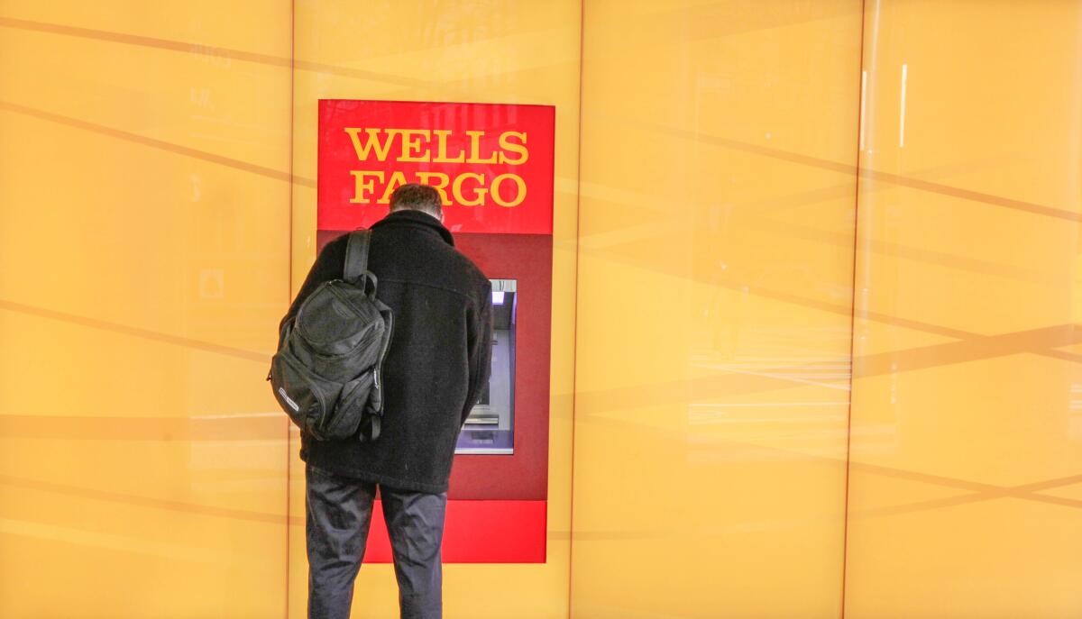 A person uses a bank ATM.