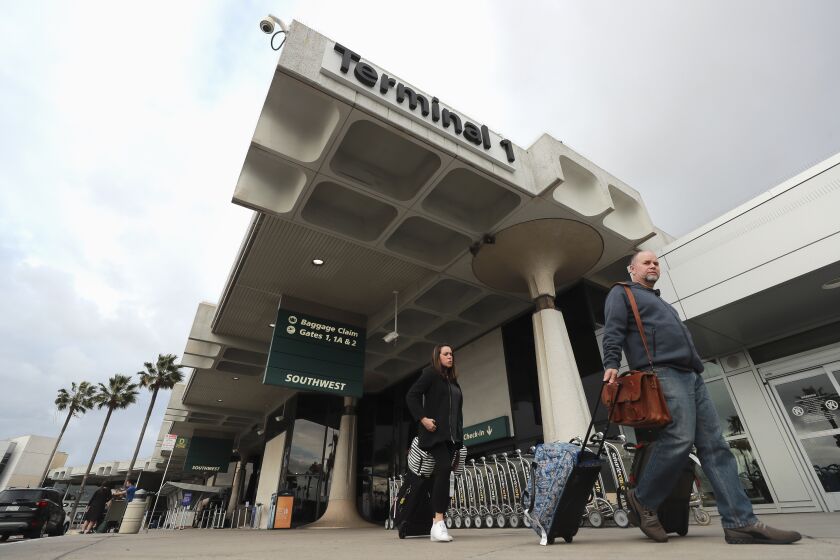 Travelers walk past Terminal 1 at the San Diego International Airport on Thursday, January 9, 2020 in San Diego, California.