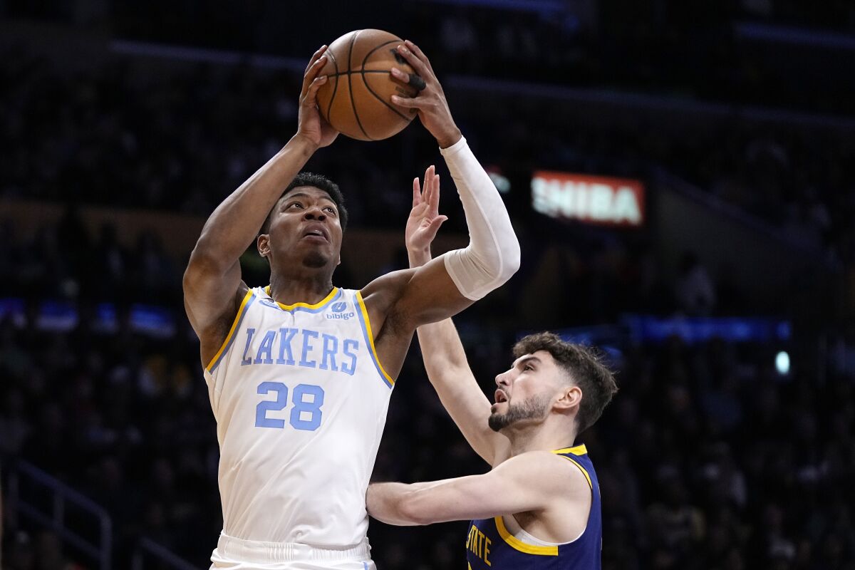 Lakers forward Rui Hachimura shoots over Golden State Warriors guard Ty Jerome.