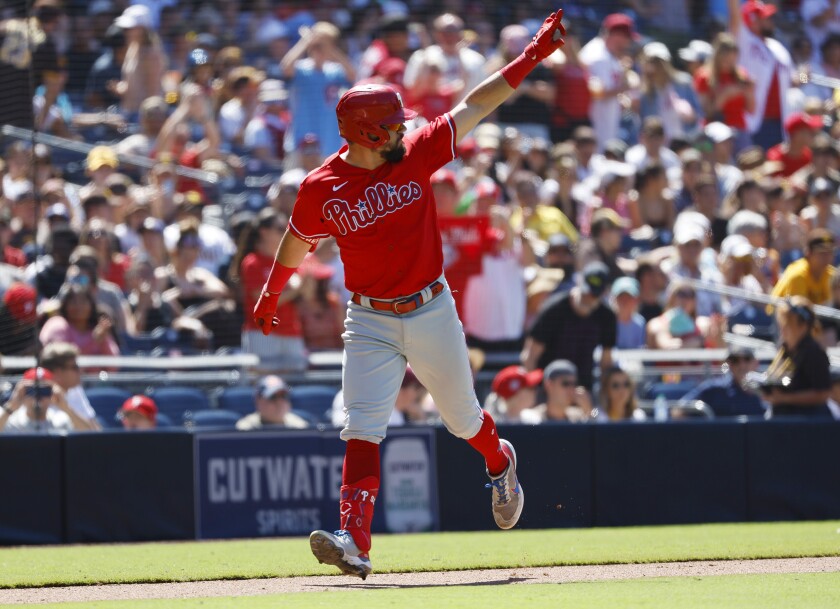 The Phillies' Kyle Schwarber celebrates a three-run home run off Padres pitcher Nabil Crismatt 