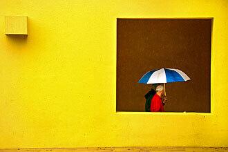 Pedestrians try to avoid the rain at Pershing Square in downtown Los Angeles.