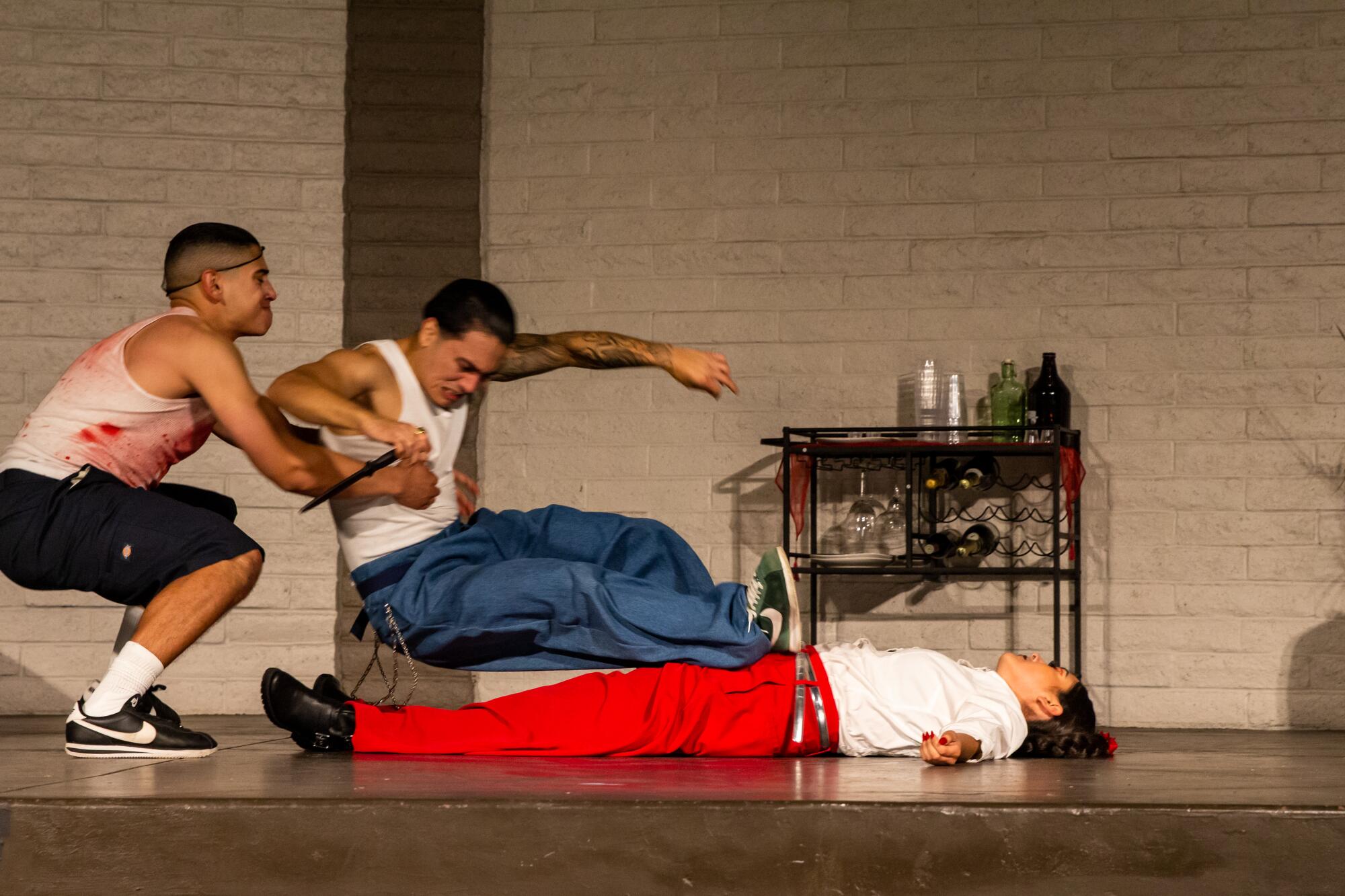 Benvolio pulls Romeo away from Tybalt's dead body on the opening night of Romeo and Juliet: Rolling through East L.A.