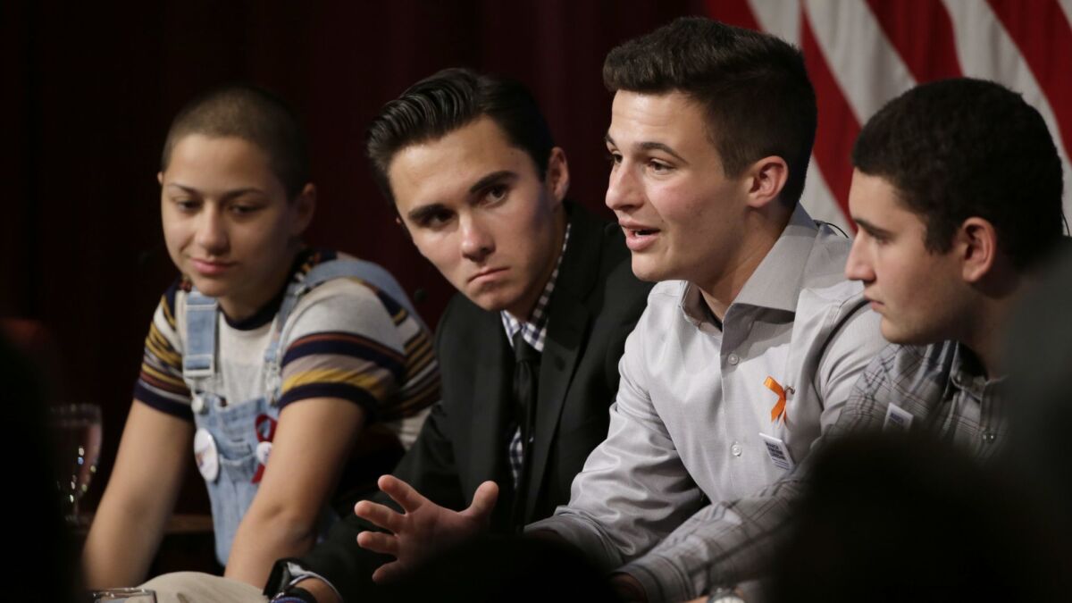 Marjory Stoneman Douglas High School students, from left, Emma Gonzalez, David Hogg, Cameron Kasky and Alex Wind participate in a panel discussion about guns Tuesday at the Harvard Kennedy School's Institute of Politics in Massachusetts.