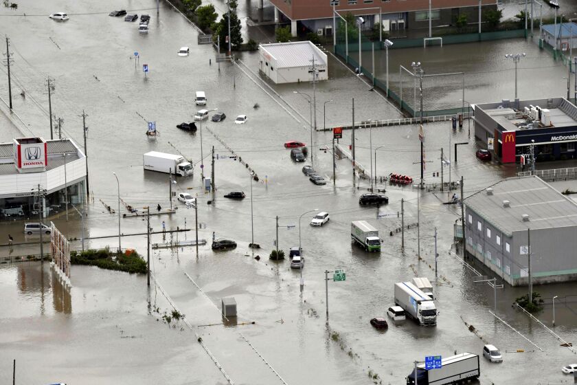 Cars are submerged on a flooded intersection due to strong rain in Toyokawa, Aichi prefecture, central Japan Saturday, June 3, 2023. Heavy rains intensified by Tropical Storm Mawar fell on Japan’s main archipelago Friday, halting trains and triggering floods and mudslides in central and western regions where residents were urged to use caution or evacuate.(Kyodo News via AP)
