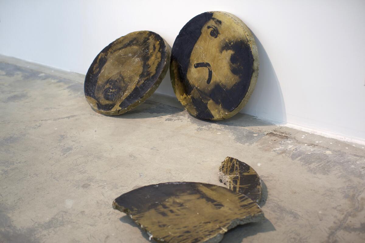 Zachary Roach's "Tablet 1," "Tablet 2" and "Tablet 3," 2016, concrete, photo emulsion, each 26 inches in diameter. (MIM Gallery)