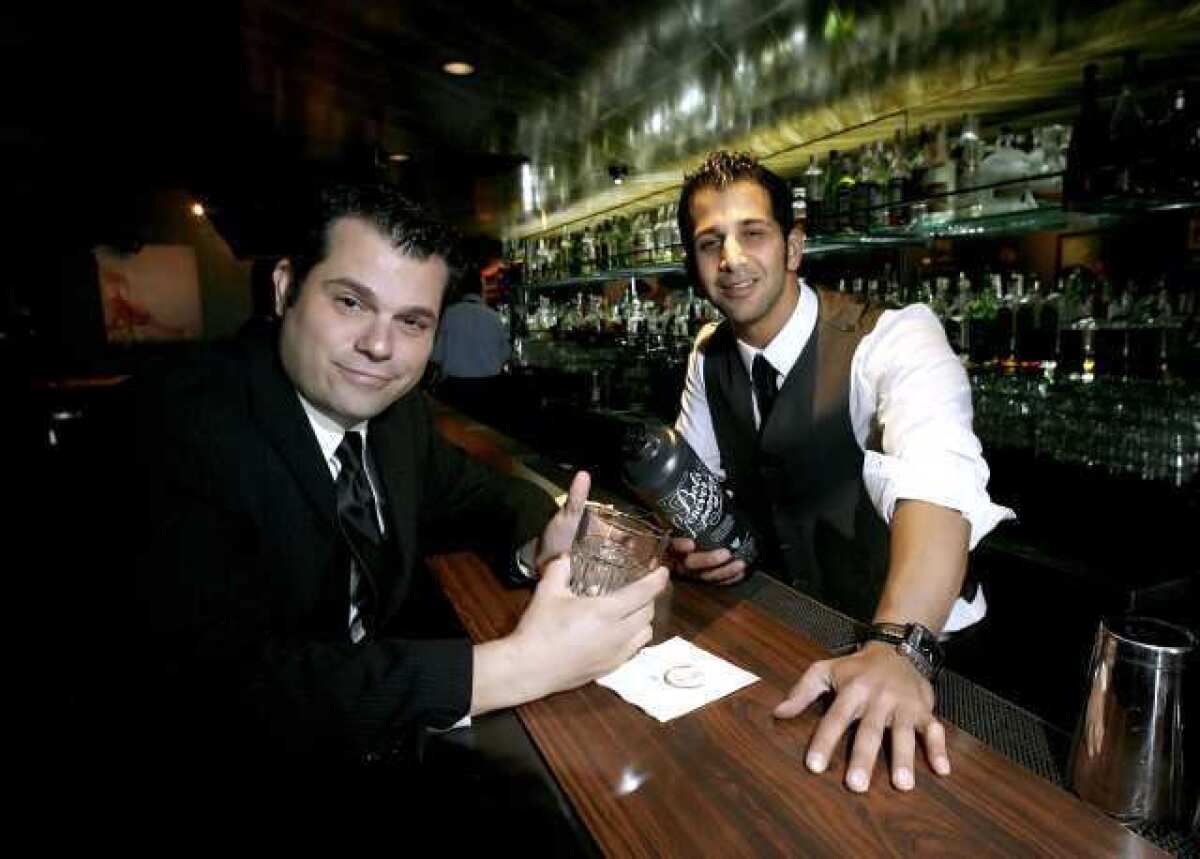 No Vacancy Entertainment's David Damiani, left, hosts a weekly Jazz Series every Wednesday at the Neat Bar in Glendale. Bartender Arash Pakzad serves up the cocktails.
