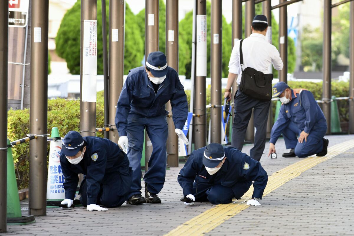 Police inspecting a sidewalk