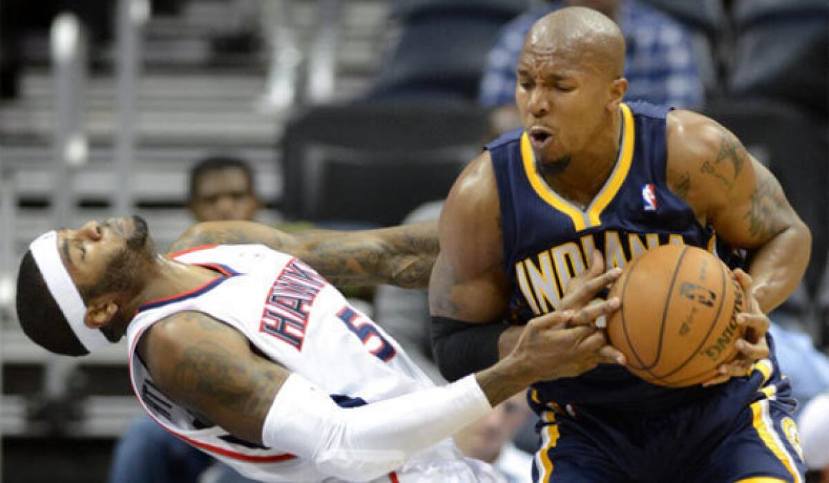 Atlanta Hawks small forward Josh Smith, left, defends Indiana Pacers power forward David West during a game at Philips Arena in Atlanta.