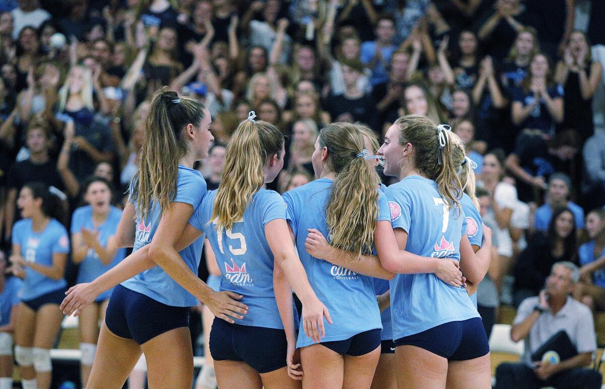 Corona del Mar players gather after winning the first set at Newport Harbor in a Sunset Conference crossover match on Thursday.