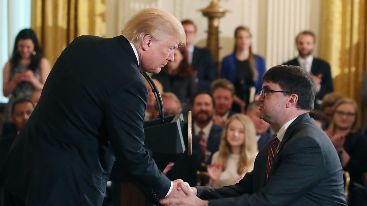 President Trump shakes hands with Robert Wilkie after announcing his nomination to be the next Veterans Affairs secretary on Friday.