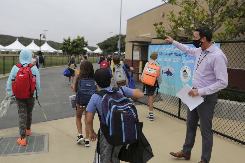 Principal Ryan Stanley welcomes students arriving for first day of in class instruction at Ocean Air School in the Del Mar Union School District Tuesday, 09/08/20. photo by Bill Wechter
