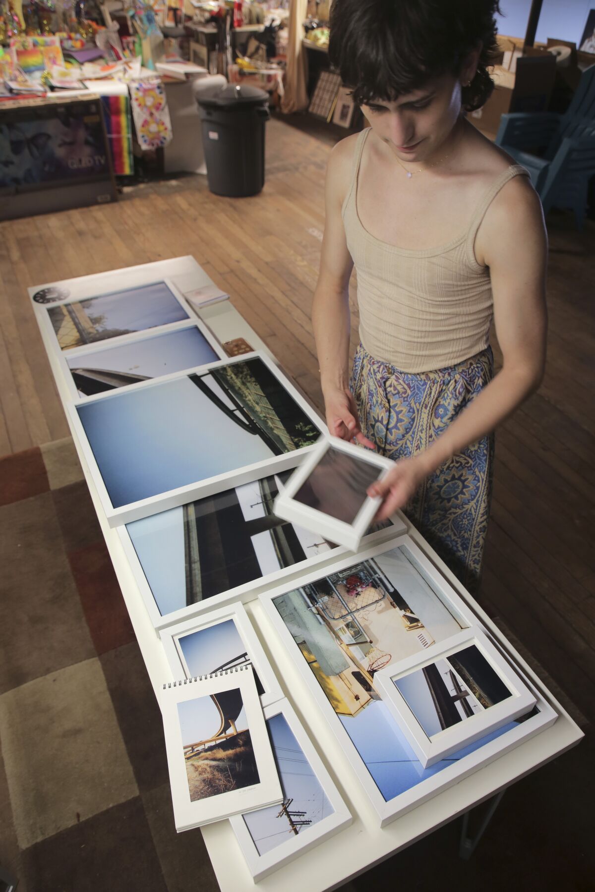 Artist Andres Hernandez with some of her work at Hill Street Country Club gallery in Oceanside on Friday, March 18.