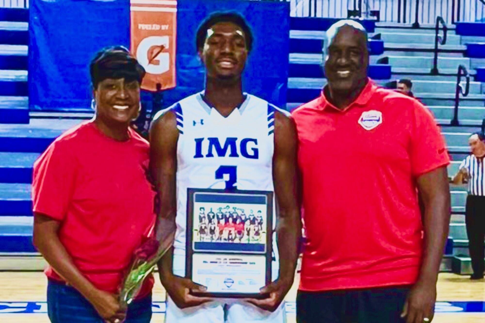 Eric Dailey Jr., center, with his parents Shell, left, and Eric, at IMG Academy in Florida.