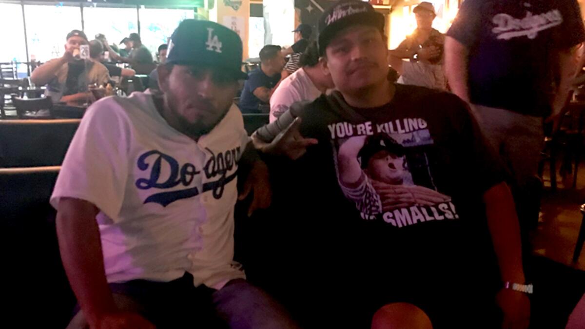 Cousins Jonathan and Jose Arangoa watch Game 1 of the World Series at The Down and Out bar in Los Angeles.