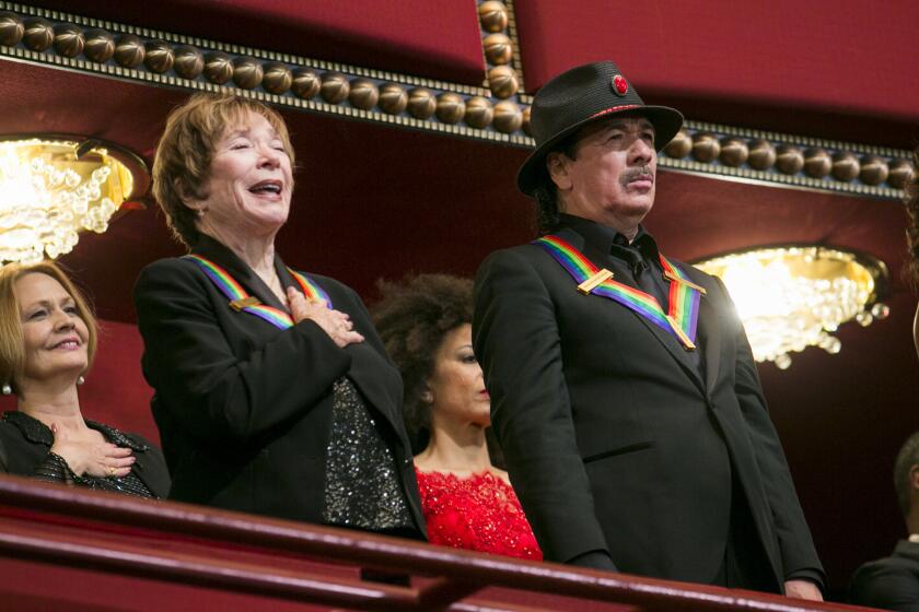 Kennedy Center Honorees Shirley MacLaine and Carlos Santana attend the 2013 Kennedy Center Honors December 2013 in Washington.